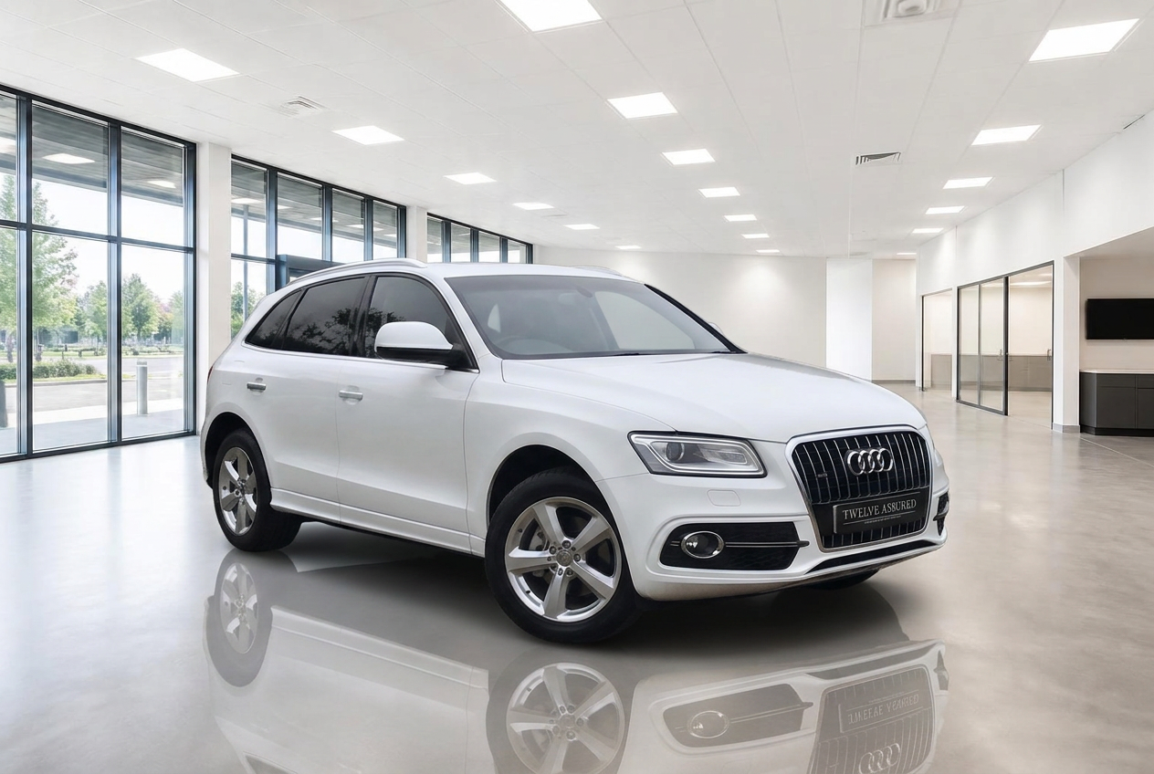 The same white Audi Q5 placed in a bright white dealership showroom